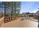 Spacious wooden deck with seating area that provides a relaxing view of the backyard and surrounding trees at 1104 Fanning Dr, Wake Forest, NC 27587