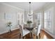 Bright dining room featuring hardwood floors and a modern light fixture, great for entertaining at 1104 Fanning Dr, Wake Forest, NC 27587