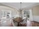 Elegant dining room with hardwood floors, a chandelier, and large windows with natural light at 1104 Fanning Dr, Wake Forest, NC 27587
