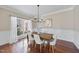 Charming dining room with hardwood floors, wainscoting, and a modern chandelier, perfect for Gathering meals at 1104 Fanning Dr, Wake Forest, NC 27587
