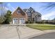 Charming brick and stone home with a well-manicured lawn and a two-car garage at 1104 Fanning Dr, Wake Forest, NC 27587