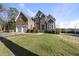 Traditional home featuring a manicured front lawn and a combination of brick and stone accents at 1104 Fanning Dr, Wake Forest, NC 27587