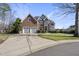 Charming brick home features a three car garage, lush landscaping, and classic architectural details at 1104 Fanning Dr, Wake Forest, NC 27587