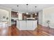 Well-appointed kitchen featuring a central island, custom cabinetry, and hardwood floors at 1104 Fanning Dr, Wake Forest, NC 27587