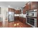 Spacious kitchen featuring stainless steel appliances, custom cabinetry, and hardwood floors at 1104 Fanning Dr, Wake Forest, NC 27587