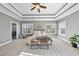 Spacious main bedroom featuring tray ceilings, two windows, carpet, and a ceiling fan at 1104 Fanning Dr, Wake Forest, NC 27587