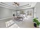 Large main bedroom featuring tray ceilings, a ceiling fan, and an ensuite bathroom at 1104 Fanning Dr, Wake Forest, NC 27587