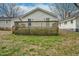 Exterior shot of a backyard with a weathered wooden deck, lawn, and house details at 1132 Gay St, Rocky Mount, NC 27804