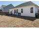 Large backyard with a well-maintained lawn, patio furniture, and a white exterior at 120 Wise Oak Ln, Garner, NC 27529