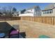 Spacious backyard with a wooden fence, green grass, and a chair with pink cushion at 120 Wise Oak Ln, Garner, NC 27529