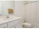 Clean bathroom features a white vanity, modern fixtures, and patterned shower curtain at 120 Wise Oak Ln, Garner, NC 27529