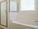 Bathroom featuring a bathtub and a separate glass-enclosed shower at 120 Wise Oak Ln, Garner, NC 27529