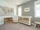 Bright Bedroom featuring a white crib, comfortable chair, and charming decor at 120 Wise Oak Ln, Garner, NC 27529