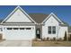 Inviting home with white siding, a two-car garage, and a well-maintained lawn at 120 Wise Oak Ln, Garner, NC 27529