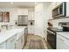Modern kitchen with stainless steel appliances, white cabinets, and a farmhouse sink at 120 Wise Oak Ln, Garner, NC 27529