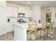 Bright kitchen with white cabinets, stainless steel appliances, and a quartz countertop island at 120 Wise Oak Ln, Garner, NC 27529