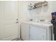 Well-lit laundry room with modern washer and dryer, storage shelves, and a clean white aesthetic at 120 Wise Oak Ln, Garner, NC 27529