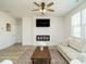 Bright living room featuring a fireplace, ceiling fan, and modern decor at 120 Wise Oak Ln, Garner, NC 27529