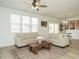 Bright living room with sofas, rug, and ceiling fan providing ample space at 120 Wise Oak Ln, Garner, NC 27529