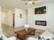 Bright living room featuring a fireplace, ceiling fan, and modern decor at 120 Wise Oak Ln, Garner, NC 27529
