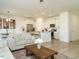 Open-concept living space with modern kitchen, cozy couch, and bright natural light at 120 Wise Oak Ln, Garner, NC 27529