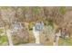 An aerial view highlights the house, its well-manicured surroundings, and its position within a wooded neighborhood at 1217 Hillingdon Way, Raleigh, NC 27614