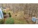 An aerial view showcases the property's backyard, with its deck, shed, and lush, mature trees at 1217 Hillingdon Way, Raleigh, NC 27614