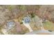 An aerial shot shows the property, surrounded by mature trees, and a long driveway at 1217 Hillingdon Way, Raleigh, NC 27614