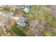 Overhead view of a blue two-story home featuring a deck, mature landscaping, and long driveway at 1217 Hillingdon Way, Raleigh, NC 27614