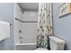 Full bathroom with tiled shower/tub featuring modern fixtures and a stylish leaf-patterned shower curtain at 1217 Hillingdon Way, Raleigh, NC 27614