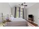 Bedroom featuring hardwood floors, a large window, and a comfortable bed at 1217 Hillingdon Way, Raleigh, NC 27614