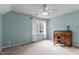 Bright bedroom with a ceiling fan, desk and ample natural light from the window at 1217 Hillingdon Way, Raleigh, NC 27614