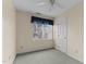 Neutral bedroom features a window, ceiling fan, and door at 1217 Hillingdon Way, Raleigh, NC 27614