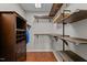 Organized walk-in closet with built-in shelving and ample storage space at 1217 Hillingdon Way, Raleigh, NC 27614