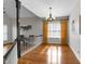 Sunlit dining room showcasing hardwood floors, elegant chandelier and staircase at 1217 Hillingdon Way, Raleigh, NC 27614