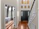 Grand entryway featuring hardwood floors, a striking black front door, and a view into an adjacent bedroom at 1217 Hillingdon Way, Raleigh, NC 27614