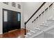 Elegant entryway with hardwood floors, staircase, and black front door with sidelight at 1217 Hillingdon Way, Raleigh, NC 27614