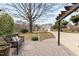 View from a brick patio showing a grassy front yard and mature trees at 1217 Hillingdon Way, Raleigh, NC 27614