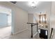 Carpeted hallway with a view of the front entryway, chandelier, and living spaces at 1217 Hillingdon Way, Raleigh, NC 27614