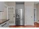 Modern kitchen features stainless steel refrigerator and convenient access to laundry and pantry at 1217 Hillingdon Way, Raleigh, NC 27614