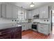 Updated kitchen with stainless steel appliances, gray cabinets, and granite countertops at 1217 Hillingdon Way, Raleigh, NC 27614