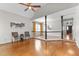 Spacious living room with hardwood floors, staircase, and natural light from windows at 1217 Hillingdon Way, Raleigh, NC 27614