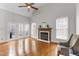 Sun-drenched living room featuring a fireplace and French doors to the exterior at 1217 Hillingdon Way, Raleigh, NC 27614