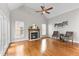 Inviting living room with a fireplace, ceiling fan, and an abundance of natural light at 1217 Hillingdon Way, Raleigh, NC 27614
