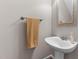 Cozy powder room featuring a pedestal sink, framed mirror and a towel rack at 1217 Hillingdon Way, Raleigh, NC 27614