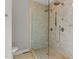 Walk-in shower featuring glass walls, rainfall showerhead, and tiled walls at 1217 Hillingdon Way, Raleigh, NC 27614