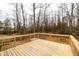 Large wooden deck with a view of the backyard and surrounding trees at 12491 Buffalo Rd, Archer Lodge, NC 27527