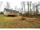Spacious backyard featuring a wooden deck, bench, and brick firepit at 12491 Buffalo Rd, Archer Lodge, NC 27527