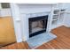 Close-up of a white fireplace with marble accents and built-in shelving at 12491 Buffalo Rd, Archer Lodge, NC 27527