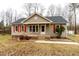 Charming ranch-style home featuring tan siding, red shutters, and a welcoming front porch at 12491 Buffalo Rd, Archer Lodge, NC 27527